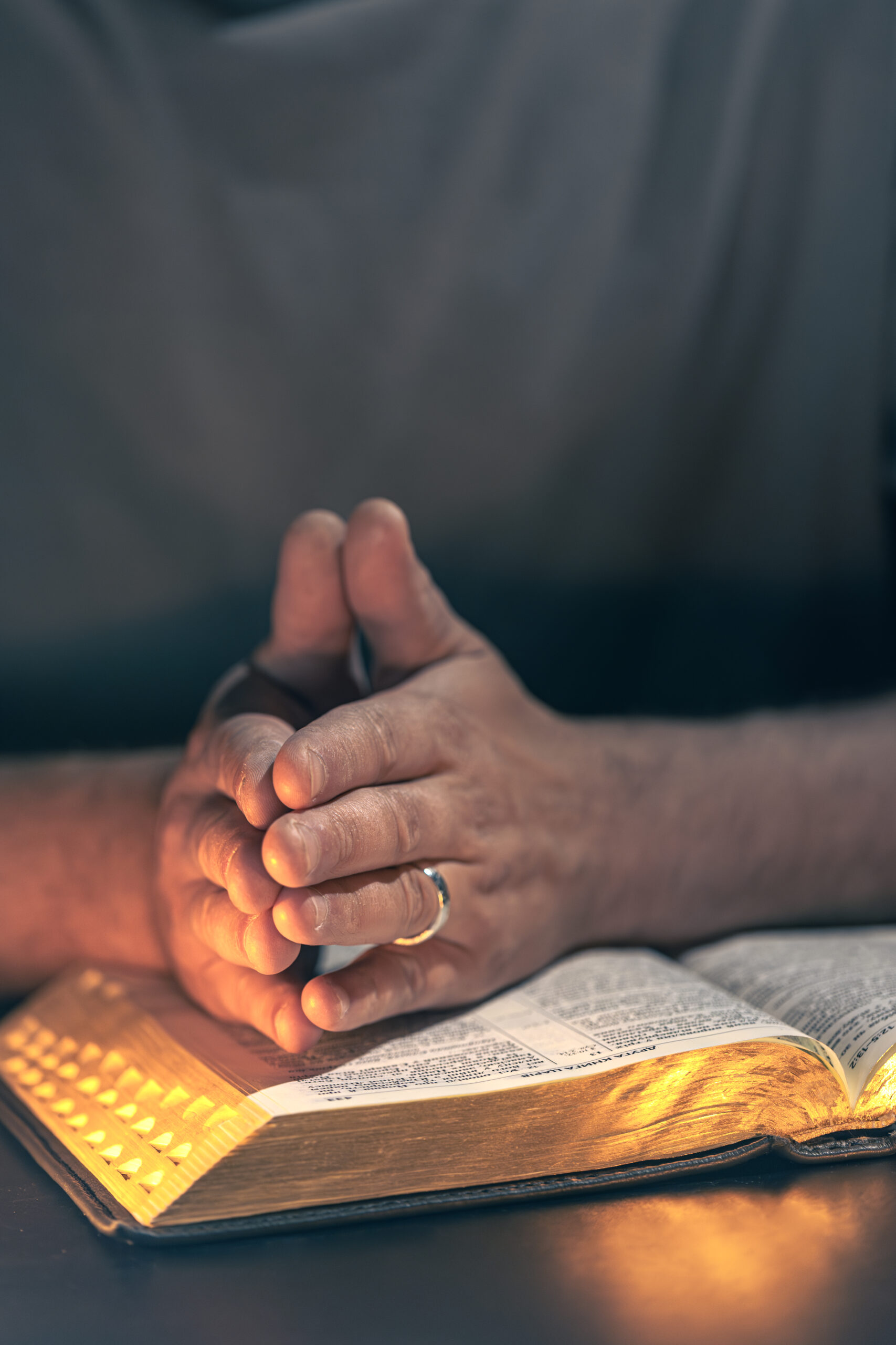 A man reads the Bible. Male hands with Bible close-up. High quality photo. Religion concept. Space for text. Male hands on the Bible.